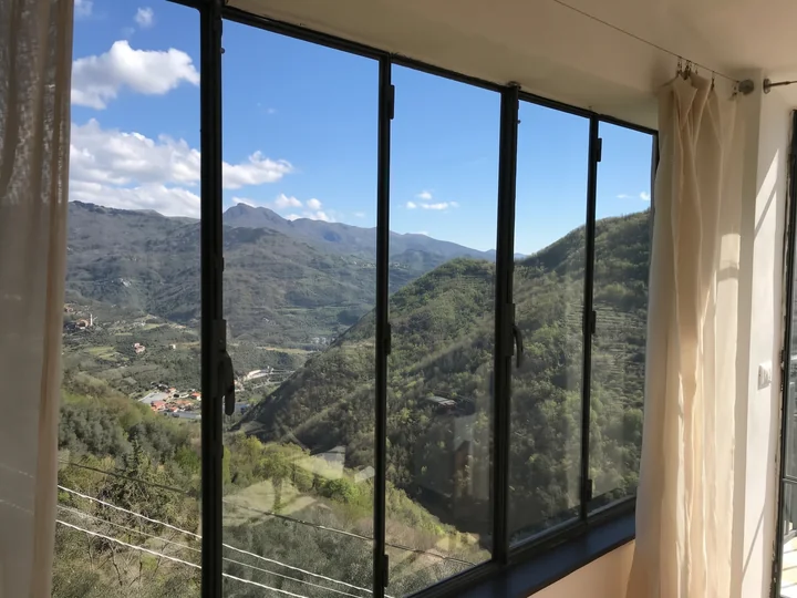 Sunlit windows at Casa Bahar overlooking the green valley and mountains