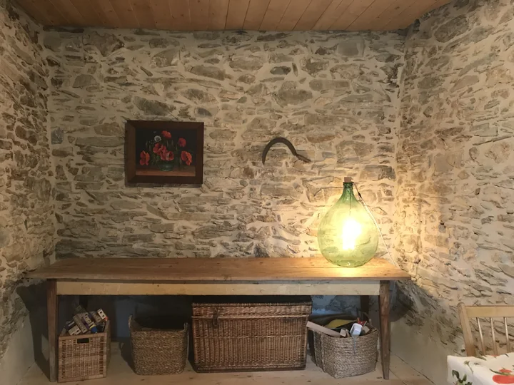 Restored stone room at Casa Bahar with a glowing glass-bottle lamp